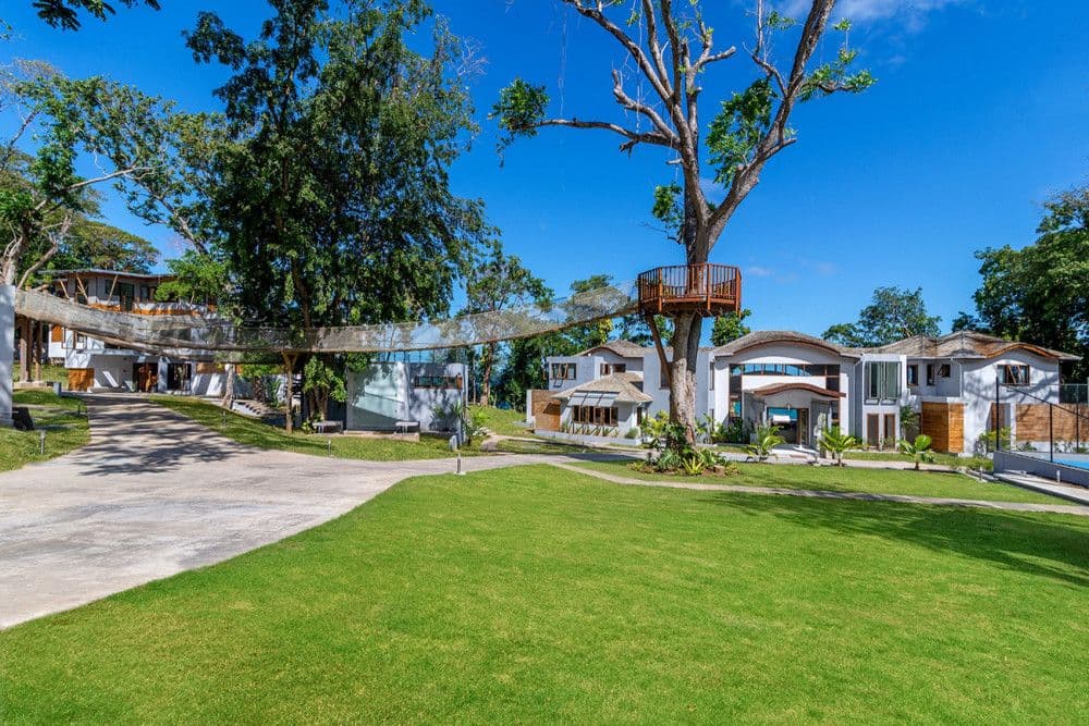 Estate grounds with a rope bridge and treetop bird-watching platform at Promiseas
