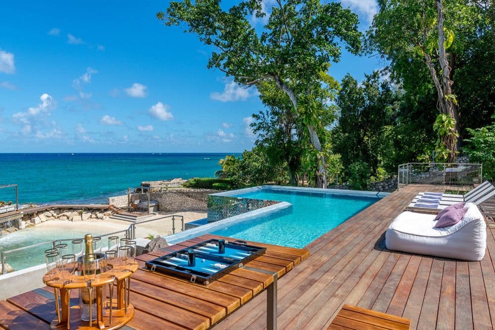 Poolside deck with loungers and sea views at Promiseas