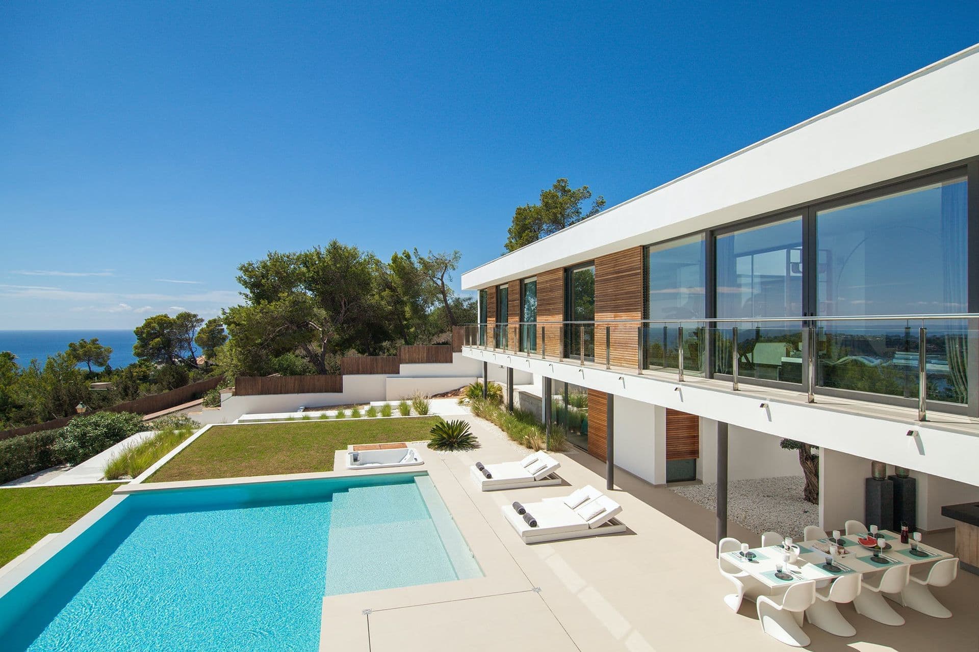 Aerial view of the minimalist Waxing Crescent villa in Ibiza with a long pool and sea-view garden
