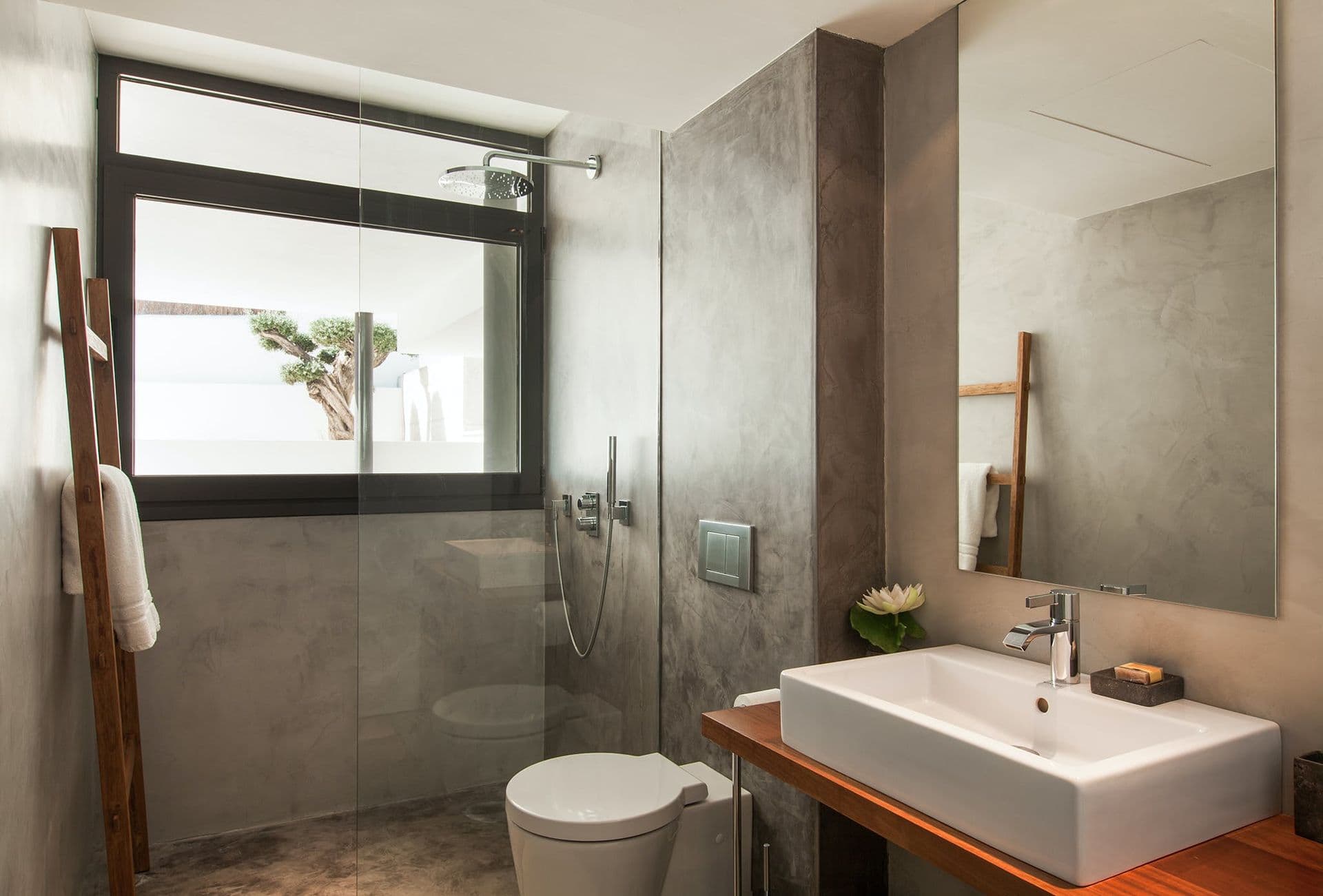 Bathroom with a walk-in shower, stone-topped vanity and countryside-view window