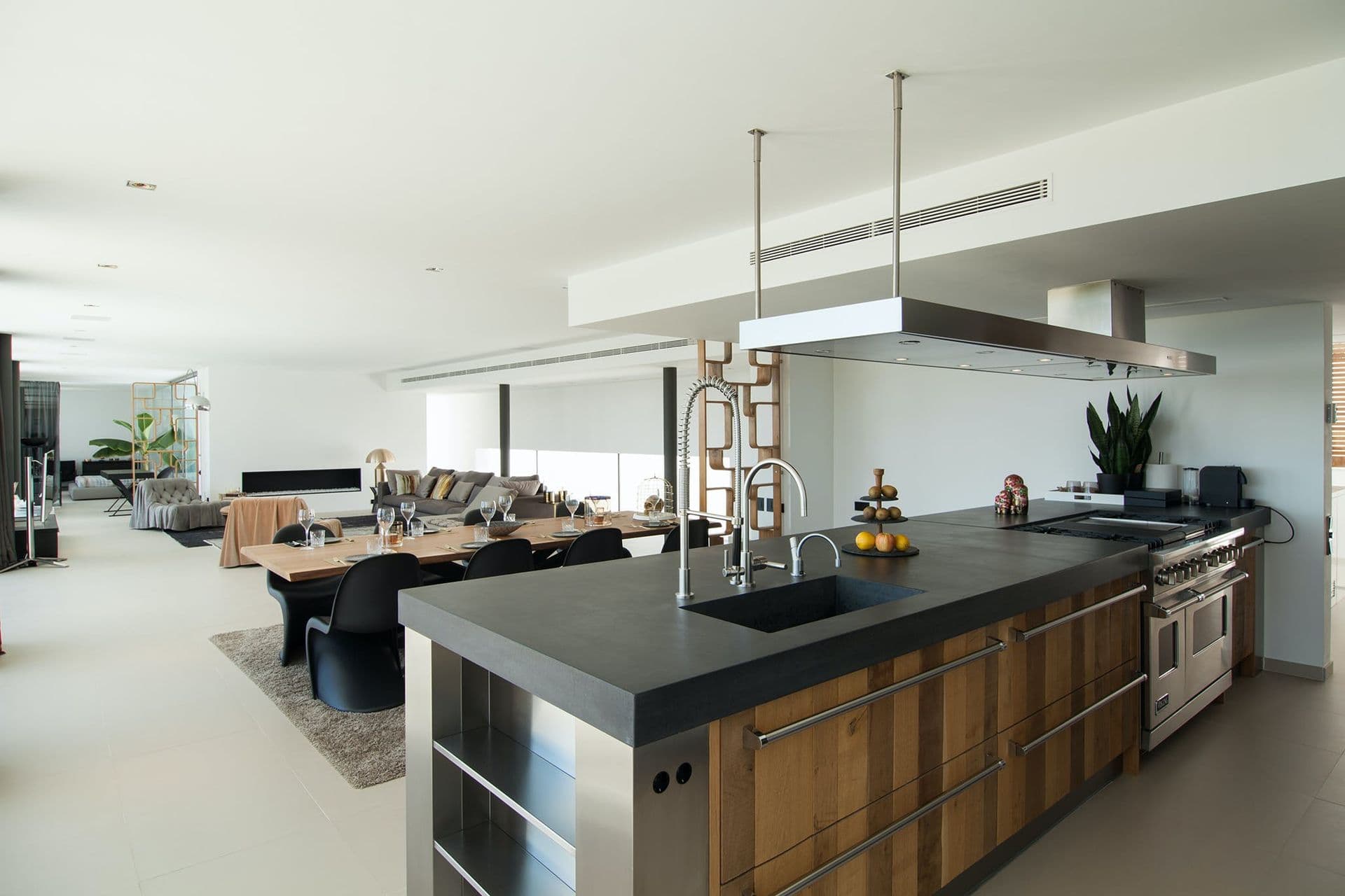 Contemporary kitchen with dark wood island, pendant lighting and countryside views