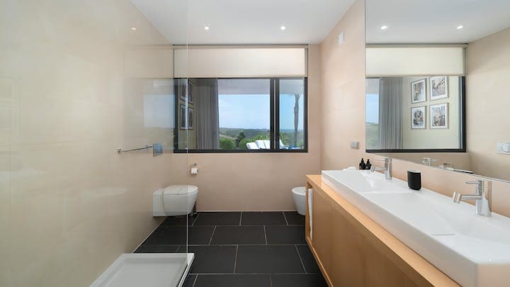 Architectural Lagos ensuite bathroom with dual sinks and hill views, Lagos, Algarve, Portugal