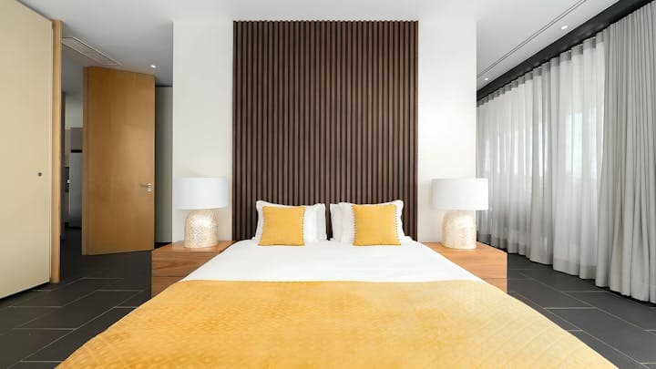 Architectural Lagos master bedroom with vertical-slat headboard, Lagos, Algarve, Portugal