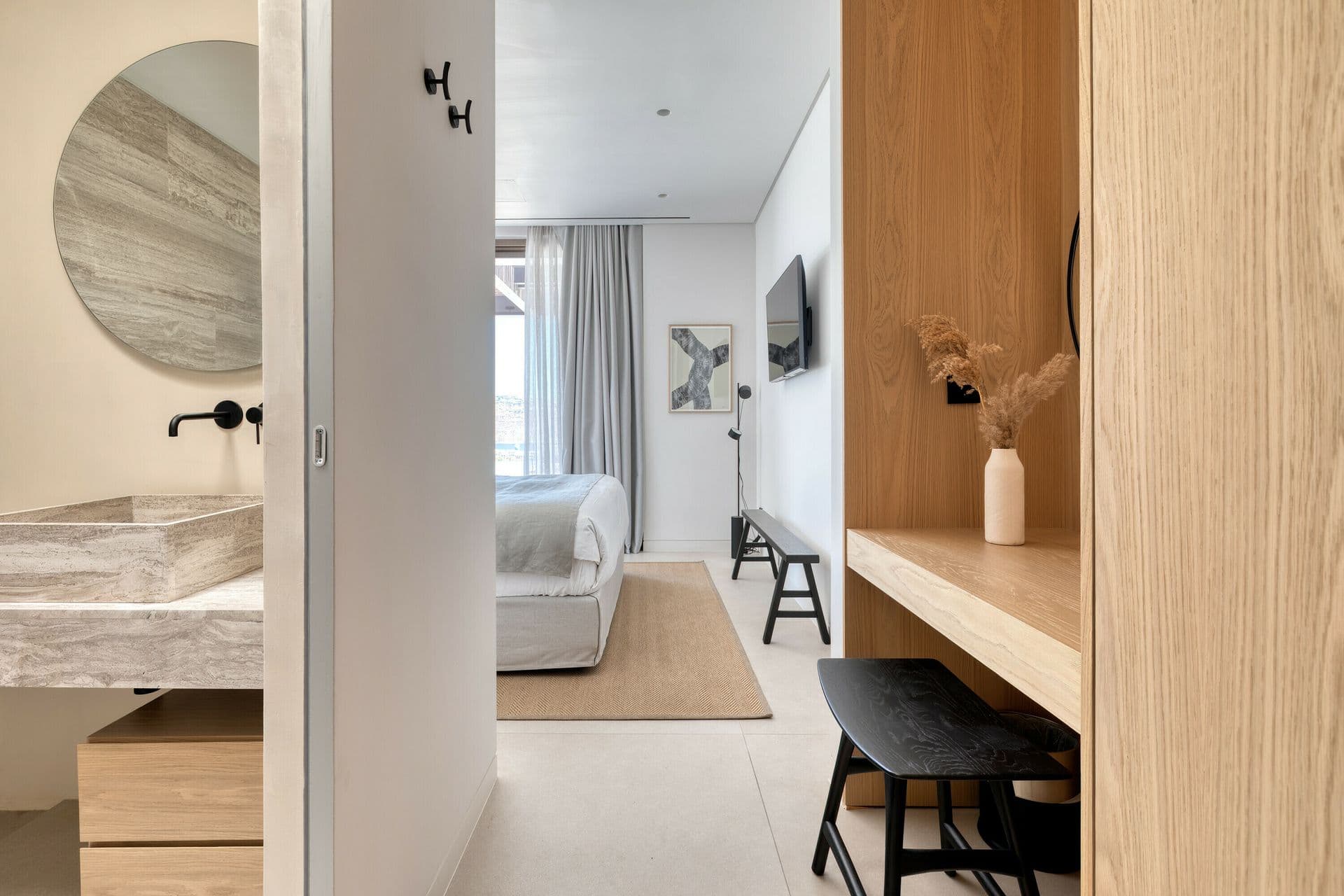 Bathroom vanity with round mirror at Ocean Breeze & Sea Views, Mykonos