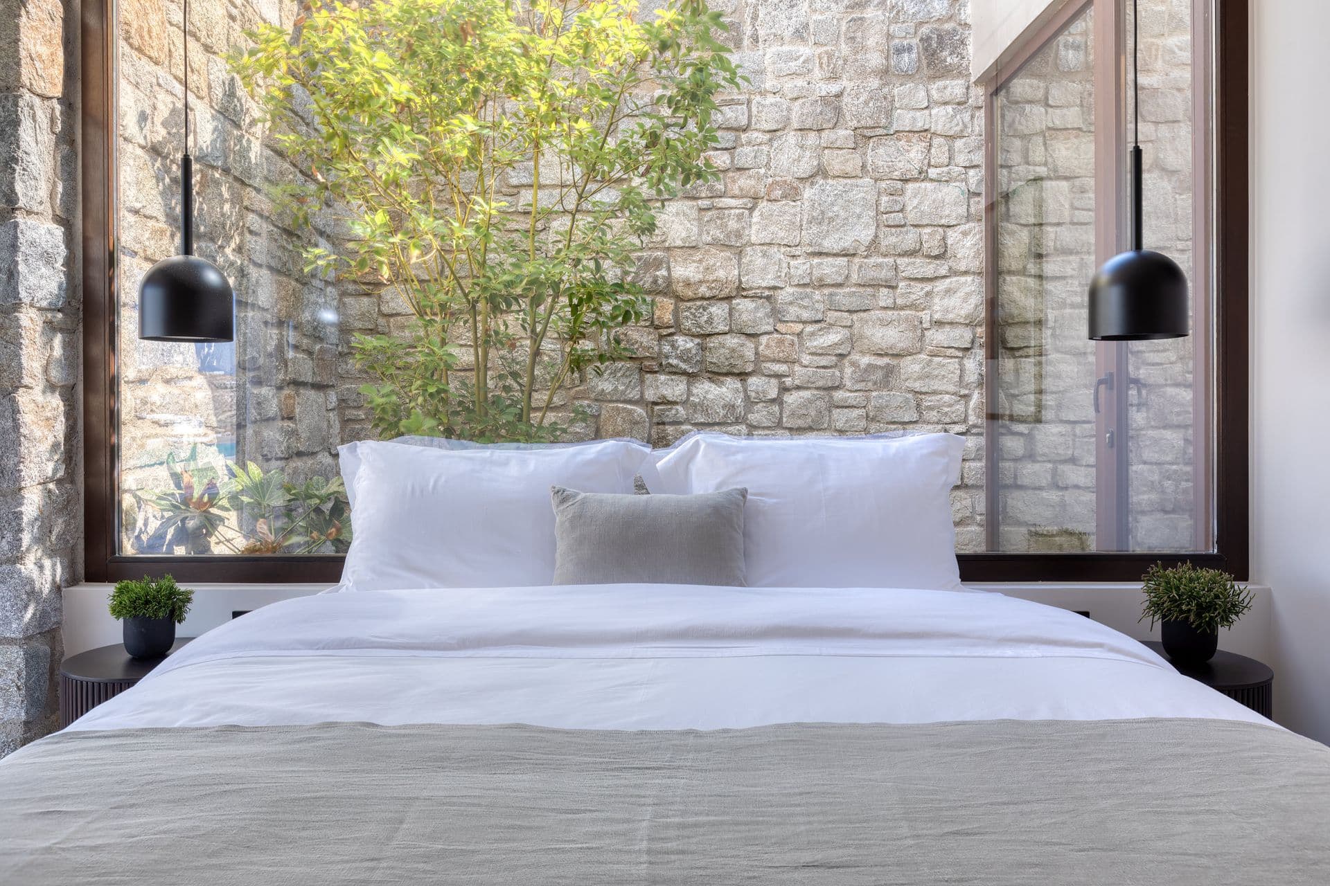 Bedroom with stone courtyard outlook at Ocean Breeze & Sea Views, Mykonos