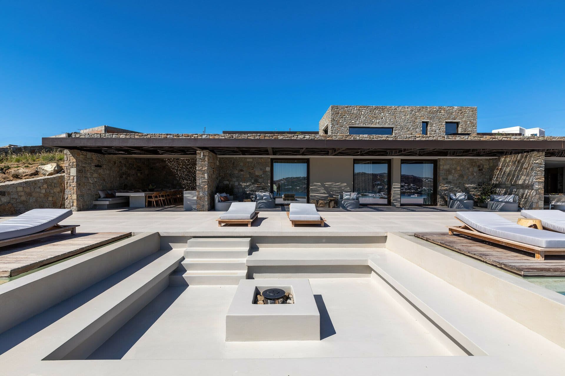 Sun terrace with fire pit lounge overlooking the sea at Ocean Breeze & Sea Views