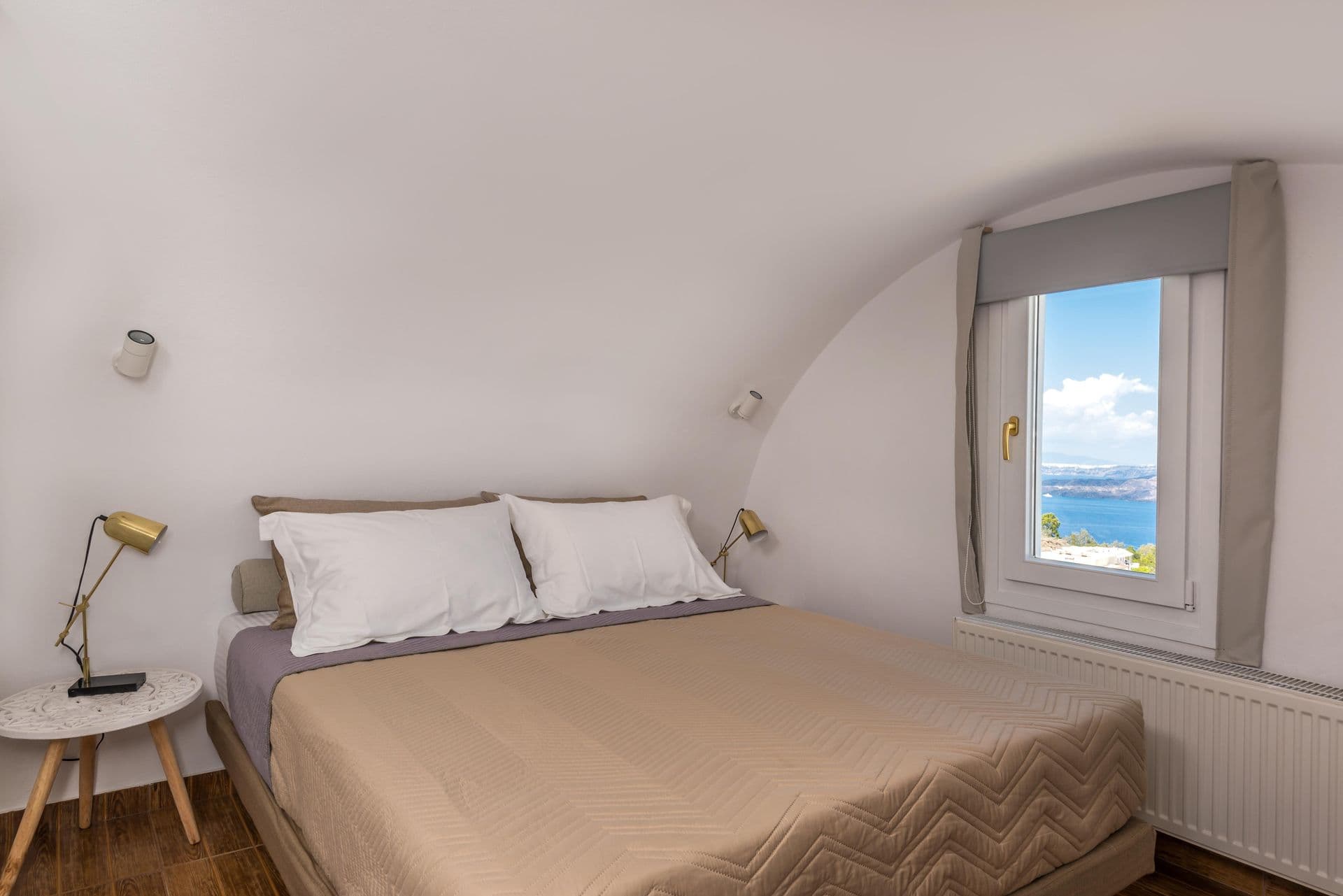 Simple double bedroom with window seating and warm lighting at Hand of Hygieia