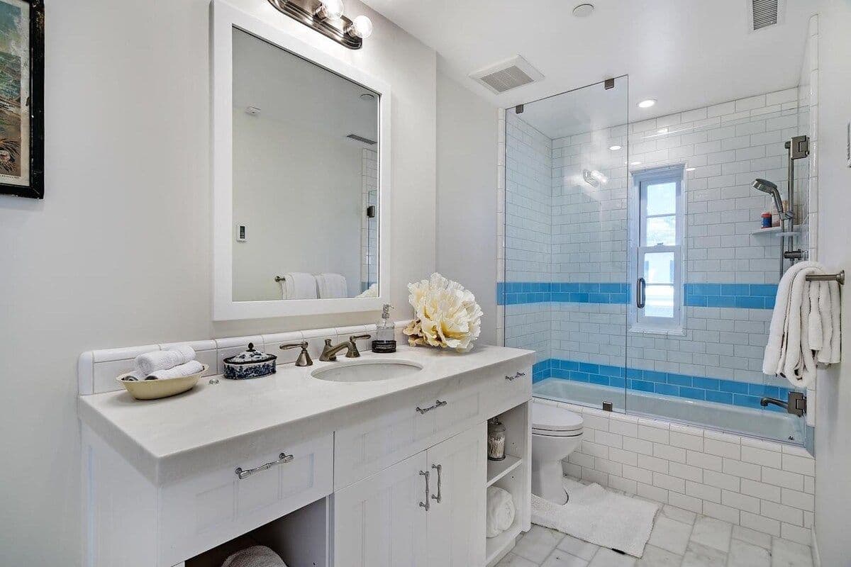 Bathroom vanity with marble countertop at Pearly Whites