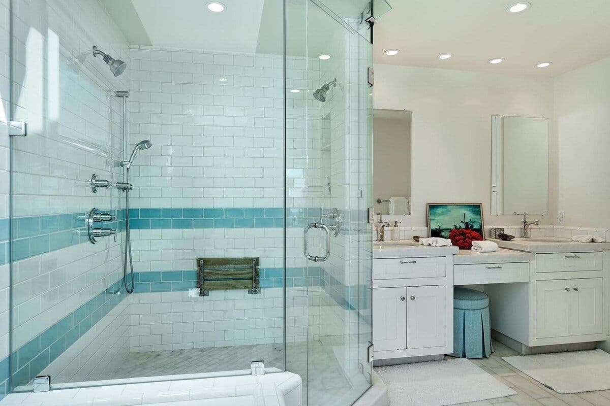 En-suite bathroom with blue-tiled walk-in shower at Pearly Whites