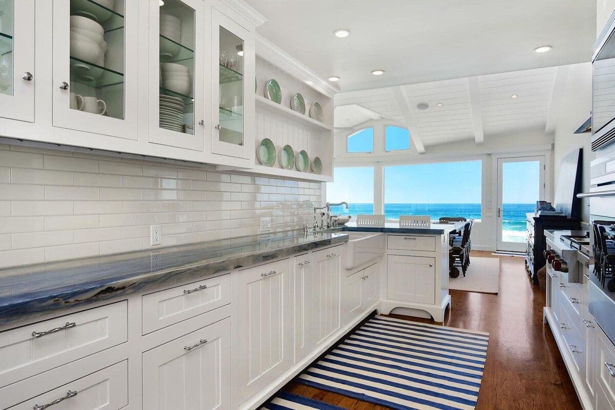 White kitchen with subway tile and ocean view at Pearly Whites