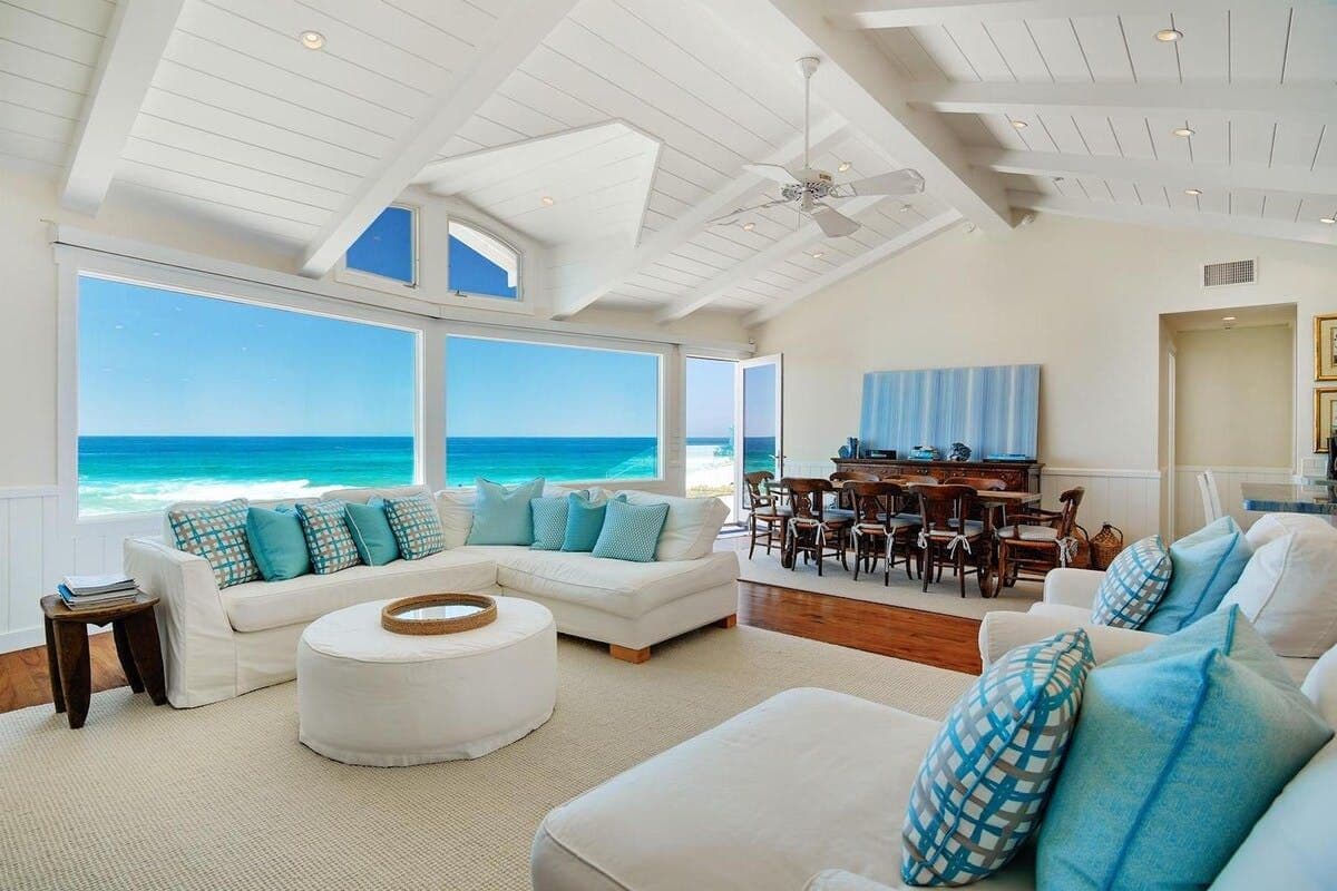 Beach-facing living room with vaulted ceiling at Pearly Whites