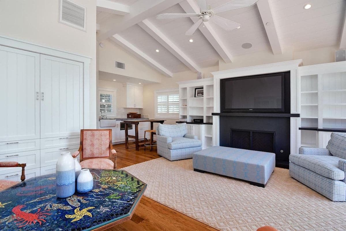 Living room with fireplace and built-in shelving at Pearly Whites