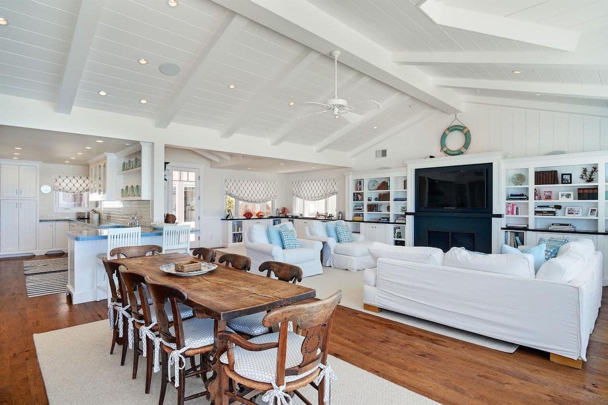 Open-plan dining and living area at Pearly Whites beach house