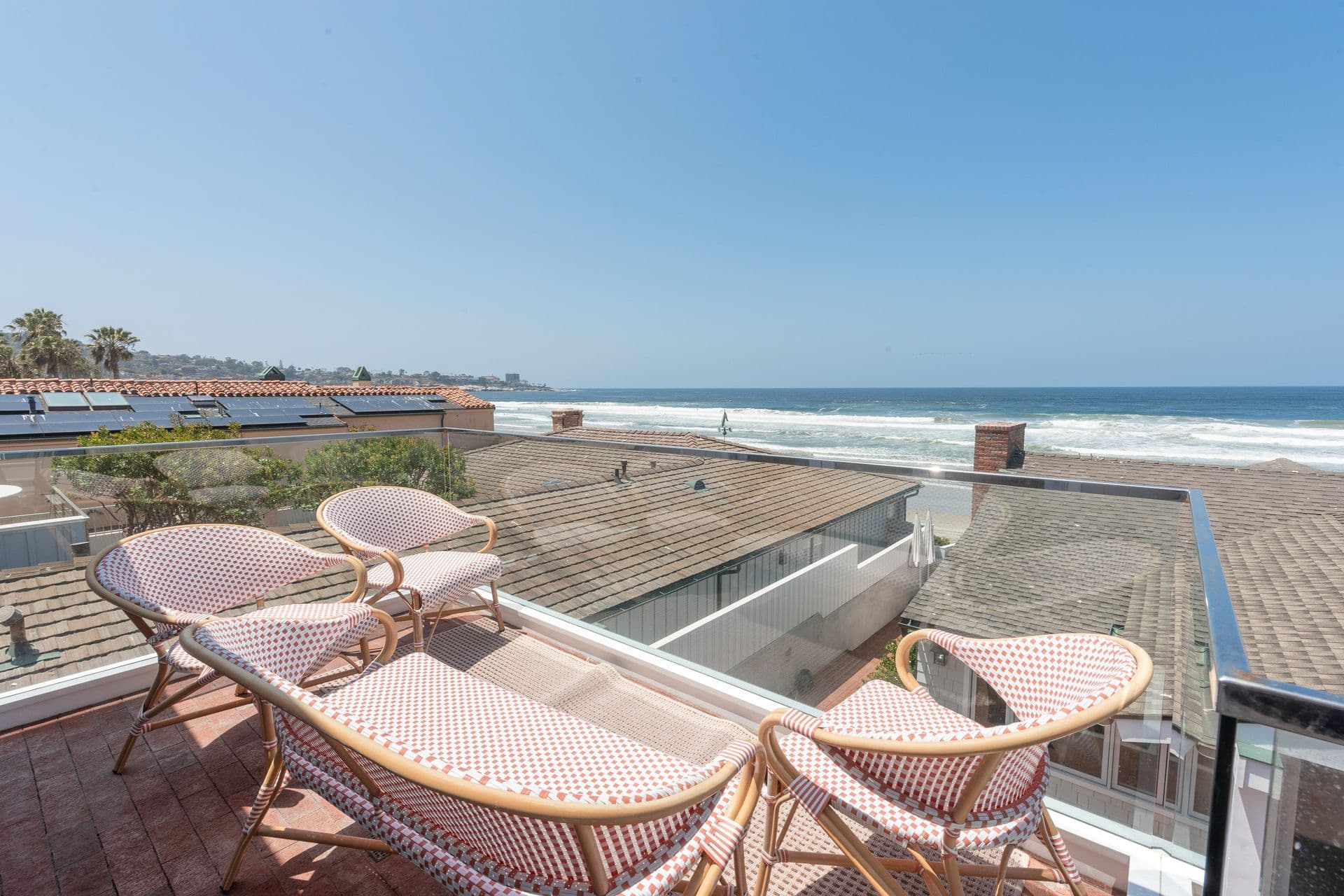 Rooftop terrace seating with ocean view at Pearly Whites