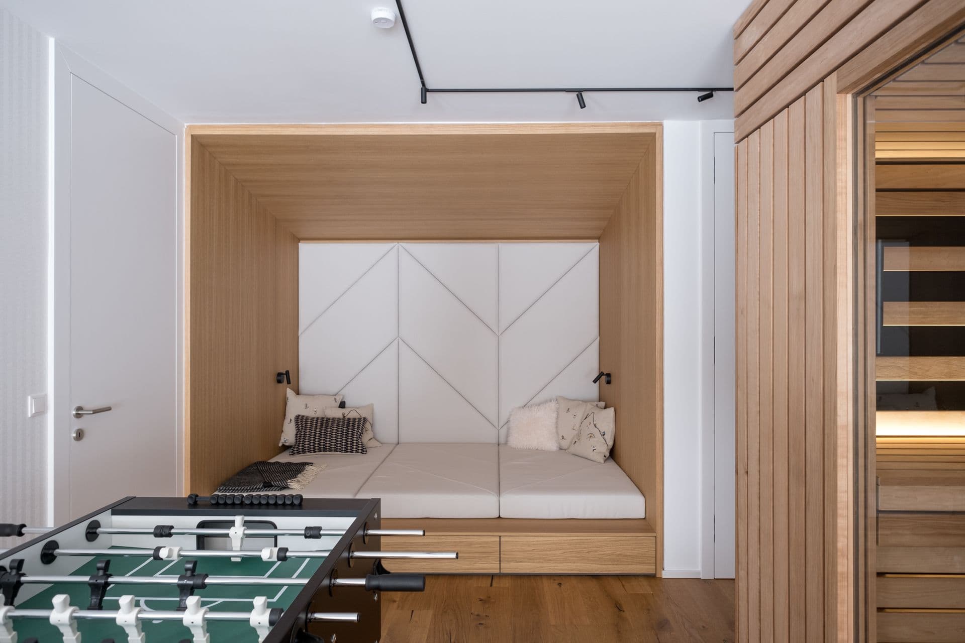 Games area with foosball table and built-in wooden bunk nook