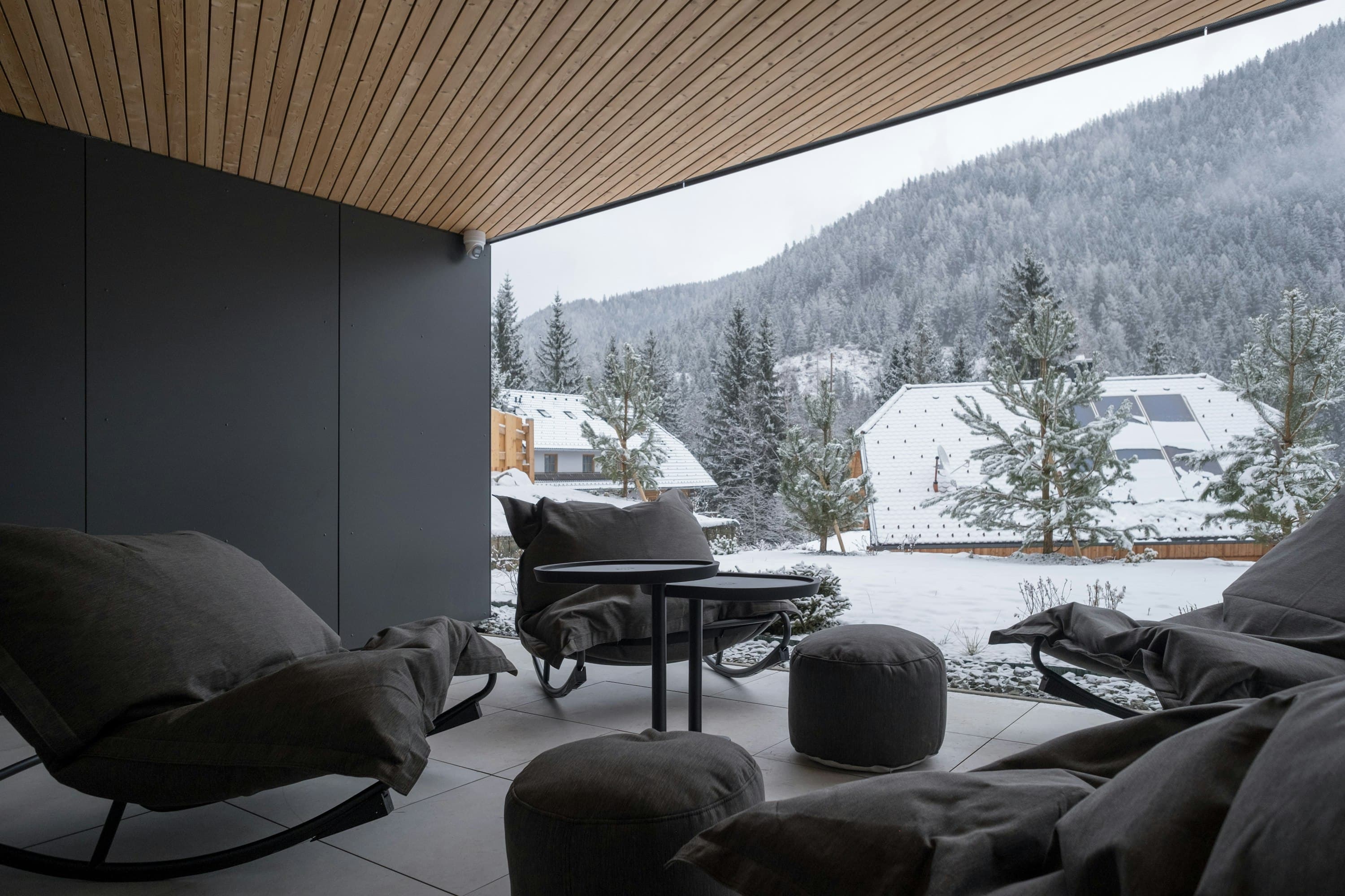 Sauna & Snowfall covered outdoor lounge terrace in winter, Paternion, Austrian Alps, Austria