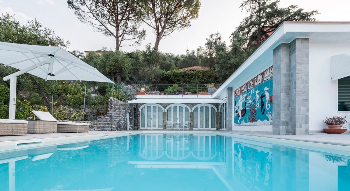 The Hillside Garden pool deck with loungers and seahorse mural, Santa Margherita Ligure, Italy