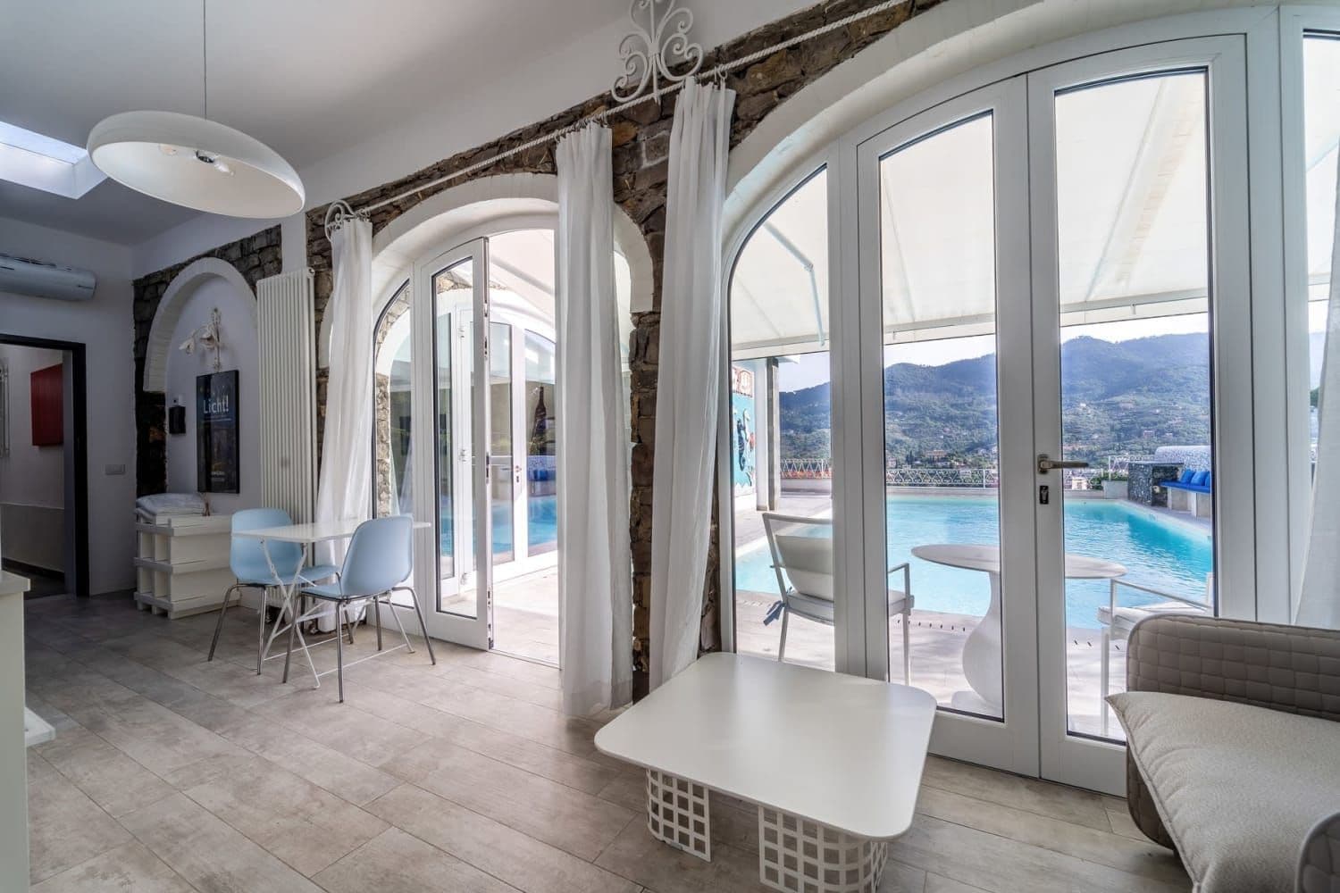 Covered arched terrace with dining area and sea view