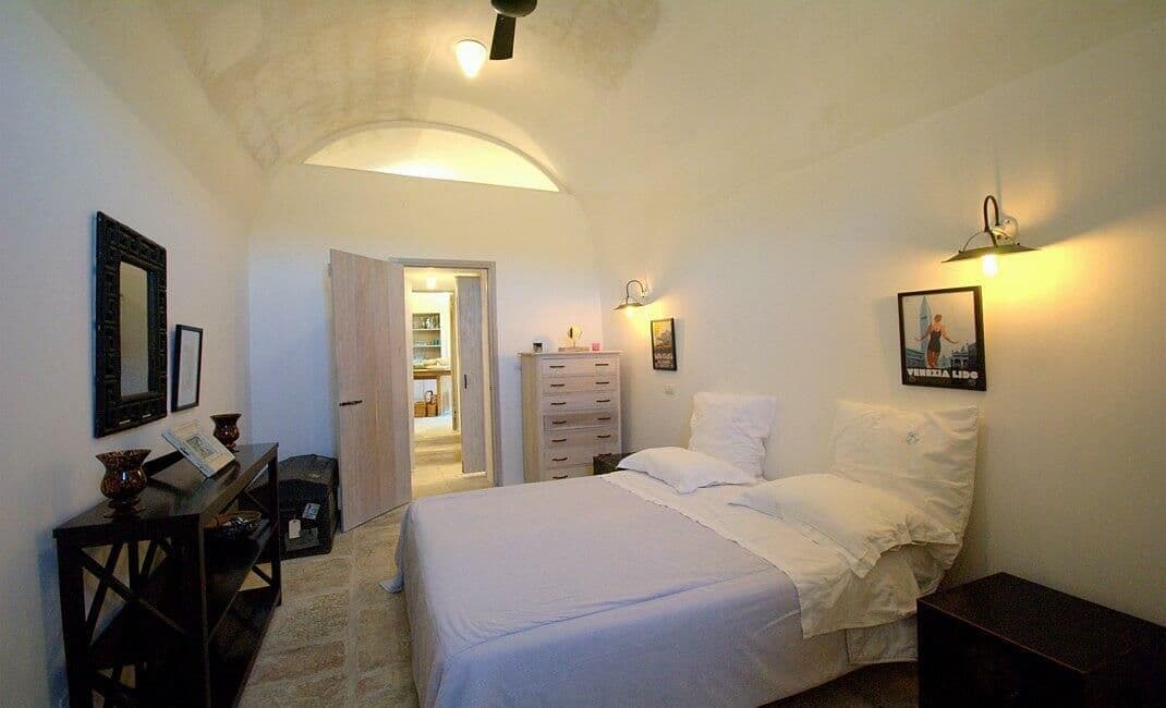 Guest bedroom with white bed linen and traditional wooden furniture