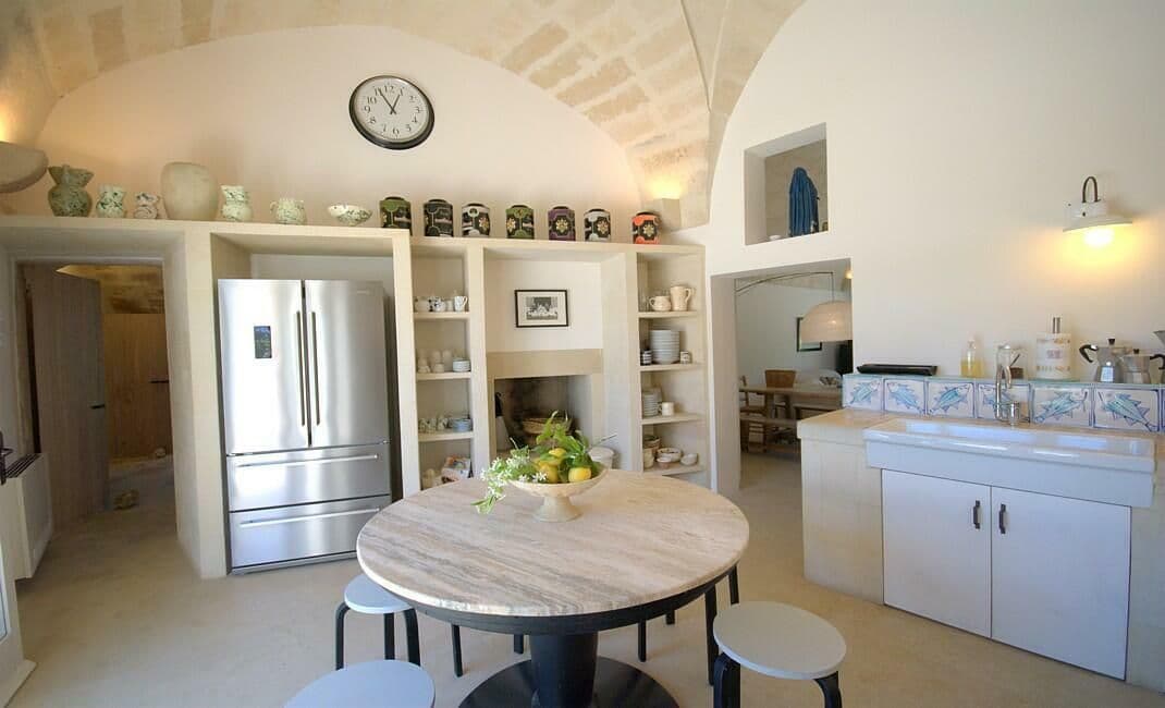 Kitchen with stainless steel fridge and hand painted tile splashback