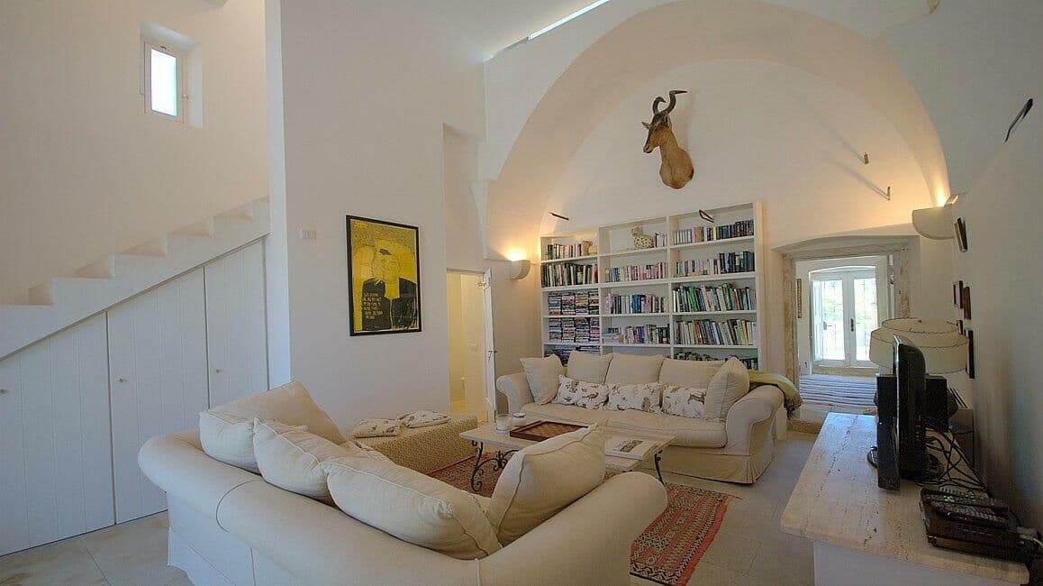 Cream sofas and arched doorways in a vaulted sitting room