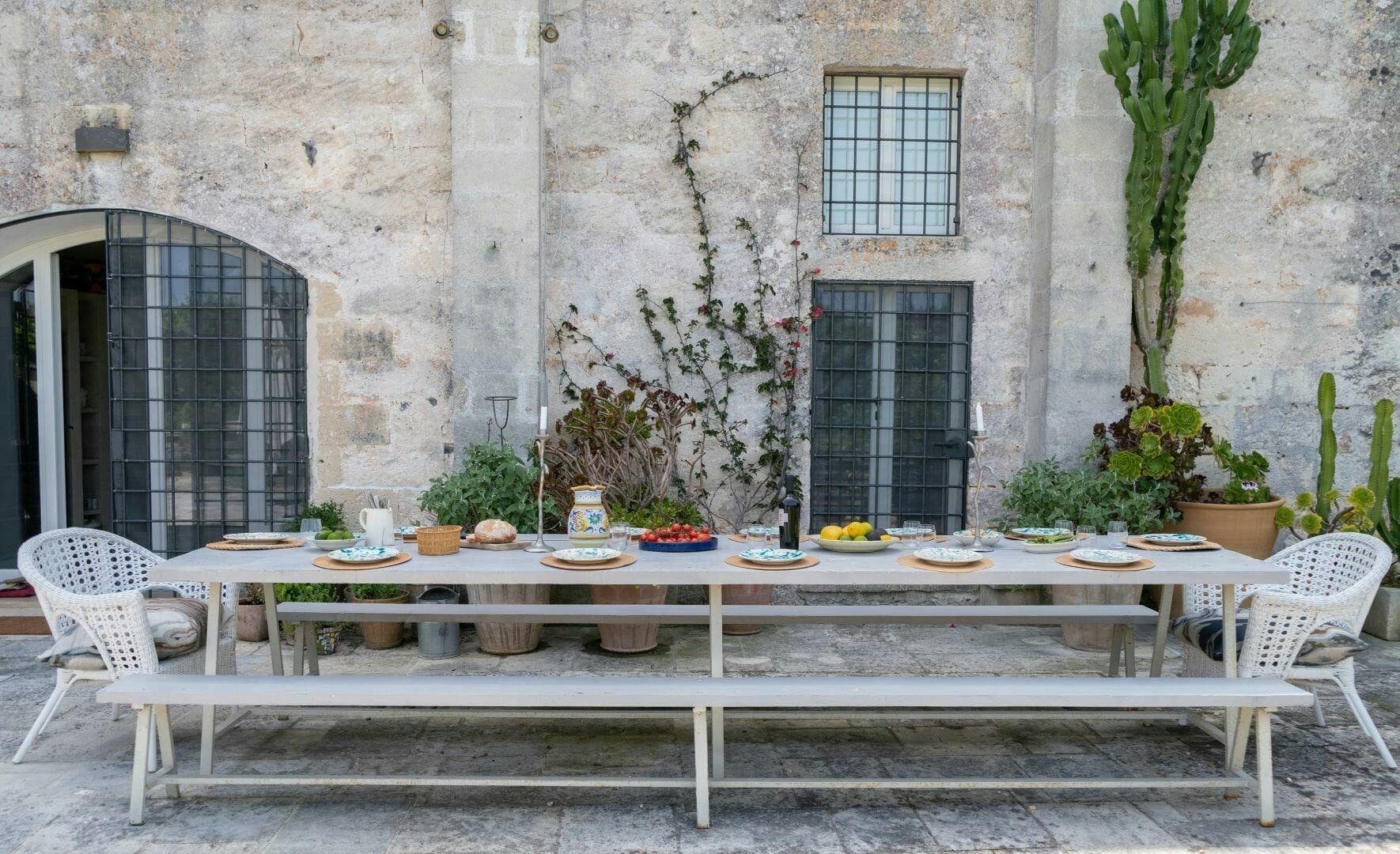 The Wise Soul outdoor dining area with rustic stone walls, Lecce, Puglia, Italy