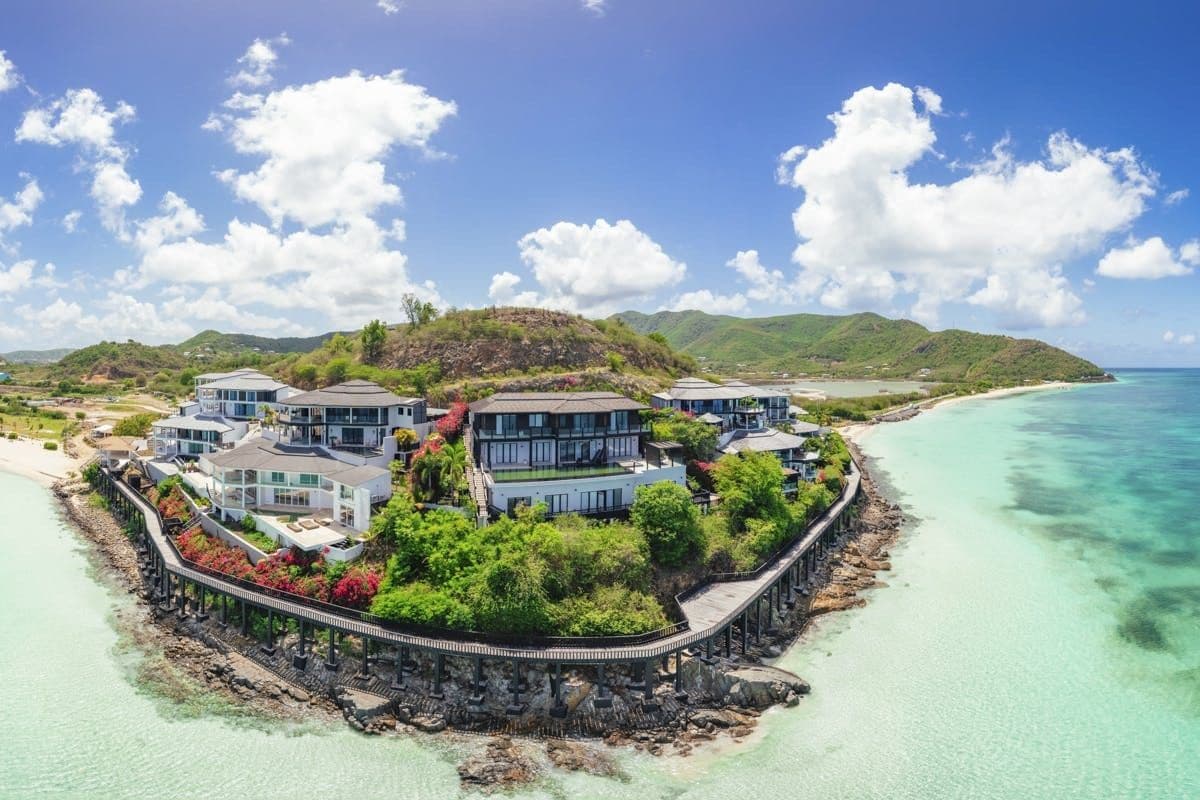 Aerial view of the hillside resort above a turquoise bay at Sunlight Breeze, Antigua