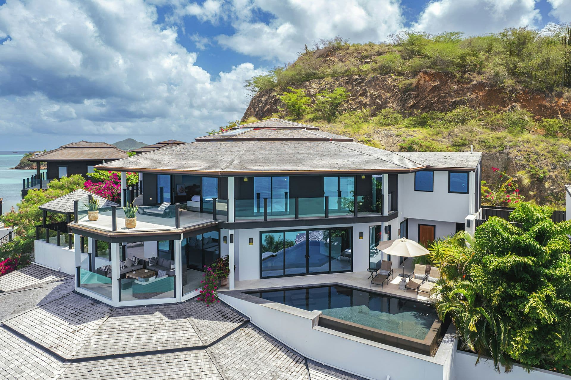 Aerial view of the villa with its two pools and terraces above the bay at Sunlight Breeze, Antigua