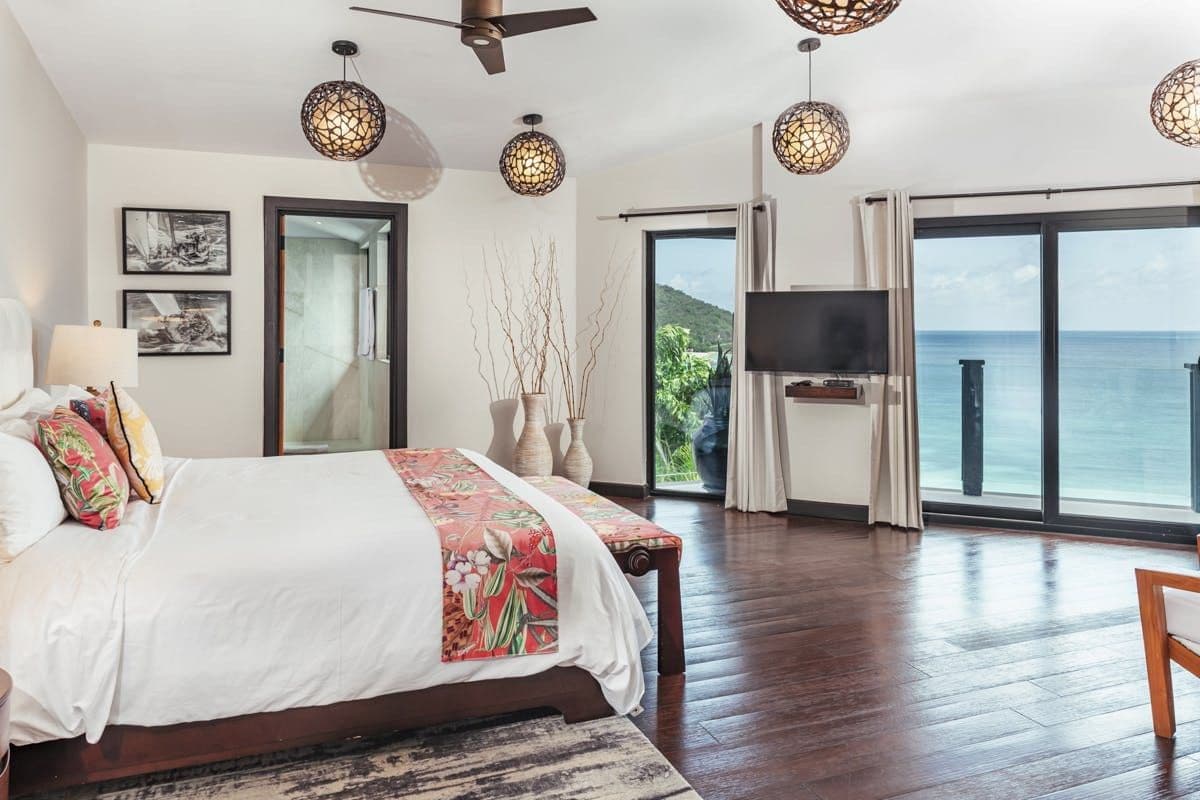 Guest bedroom with sea views and terrace access at Sunlight Breeze, Antigua