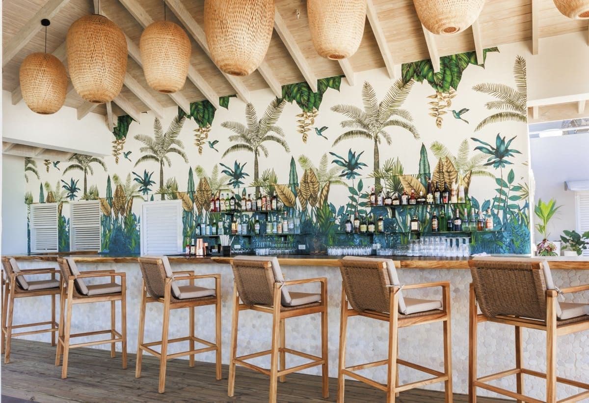 Resort bar with a tropical mural at Sunlight Breeze, Antigua