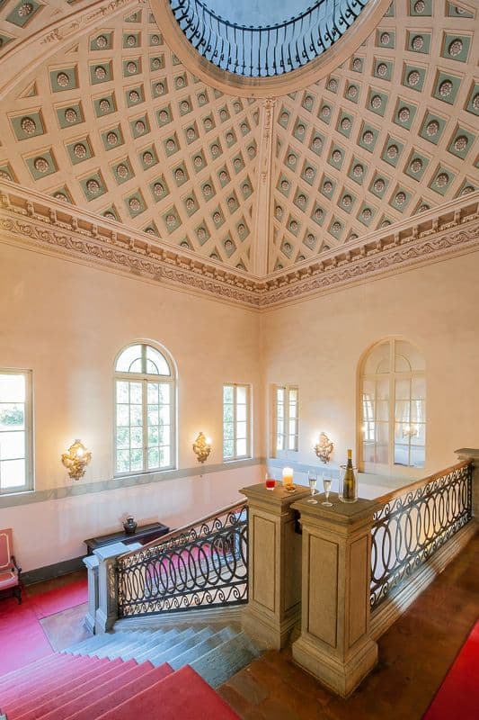 Grand stairwell rising to a domed skylight ceiling with arched windows at Midnight Ball