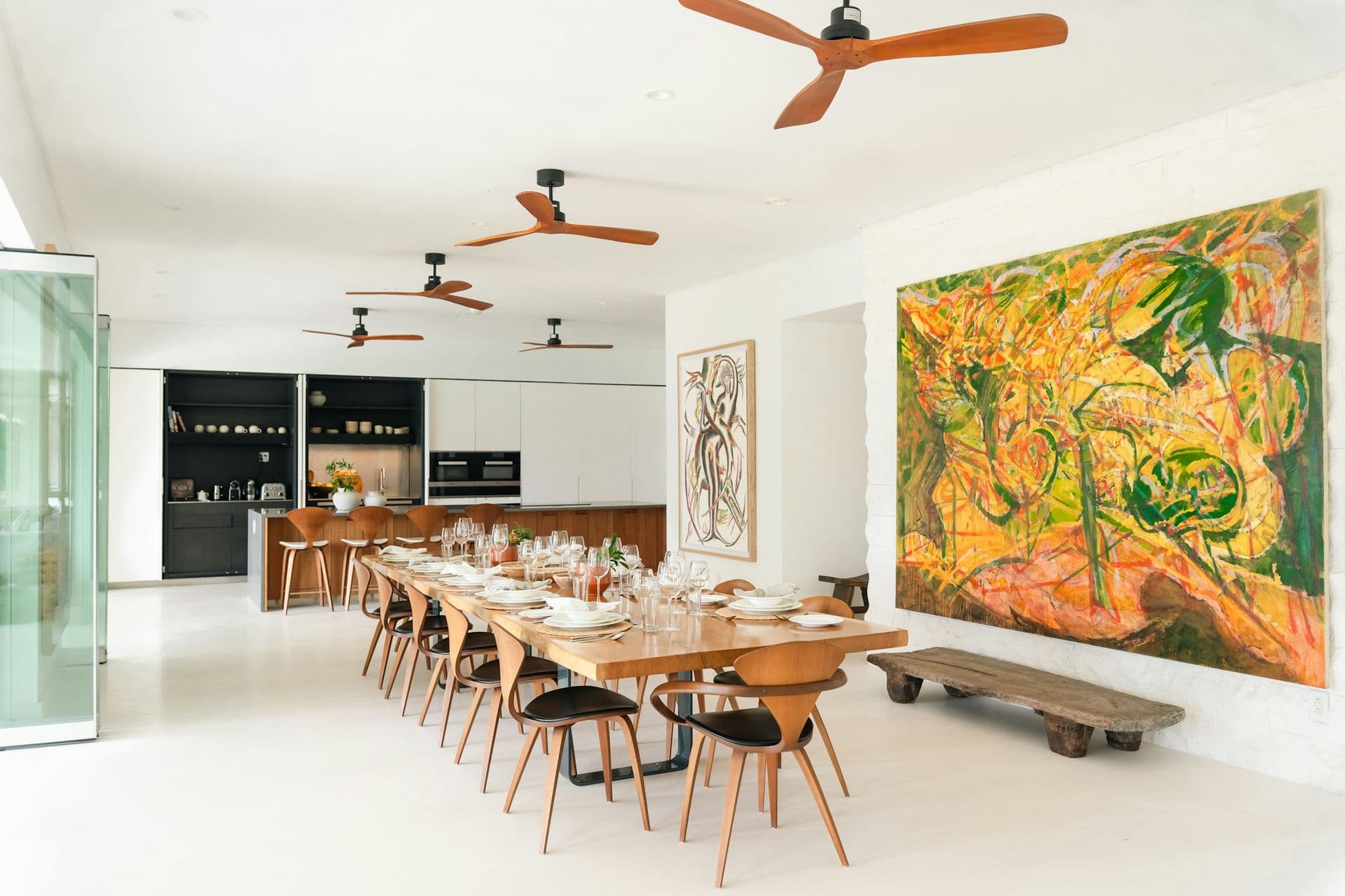 Indoor dining room with a long table and large artworks at Moonlight Beauty, Barbados