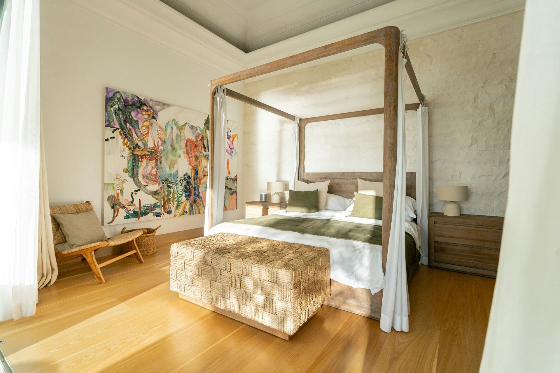 Bedroom with a timber four-poster bed and contemporary art at Moonlight Beauty, Barbados