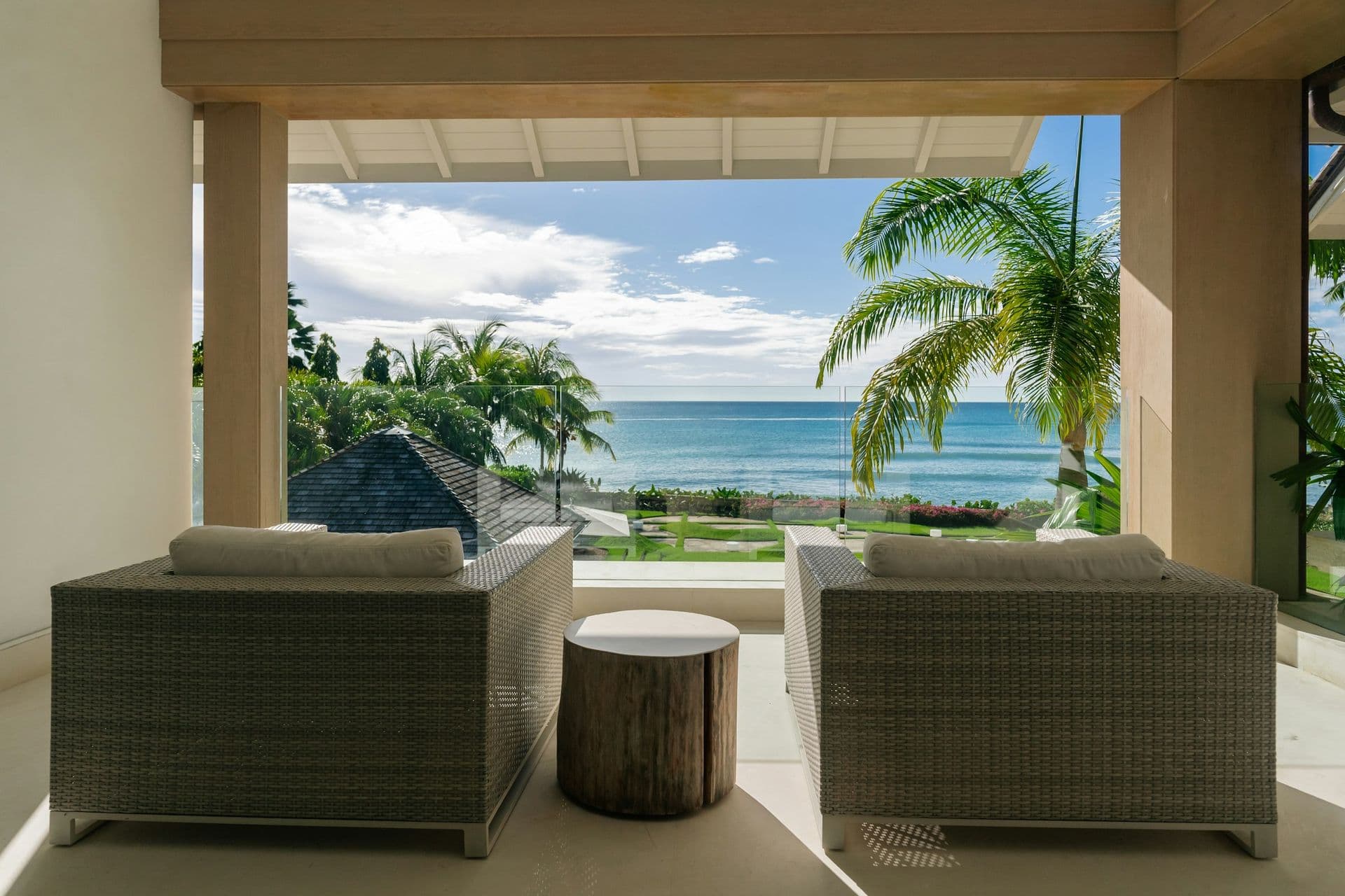 Guest bedroom opening to a terrace with loungers and sea views at Moonlight Beauty, Barbados