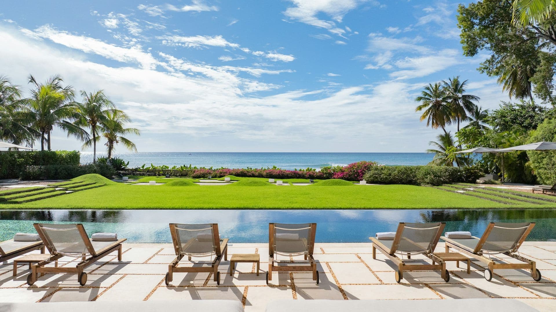 Long pool and manicured lawn running to the sea at Moonlight Beauty, Barbados