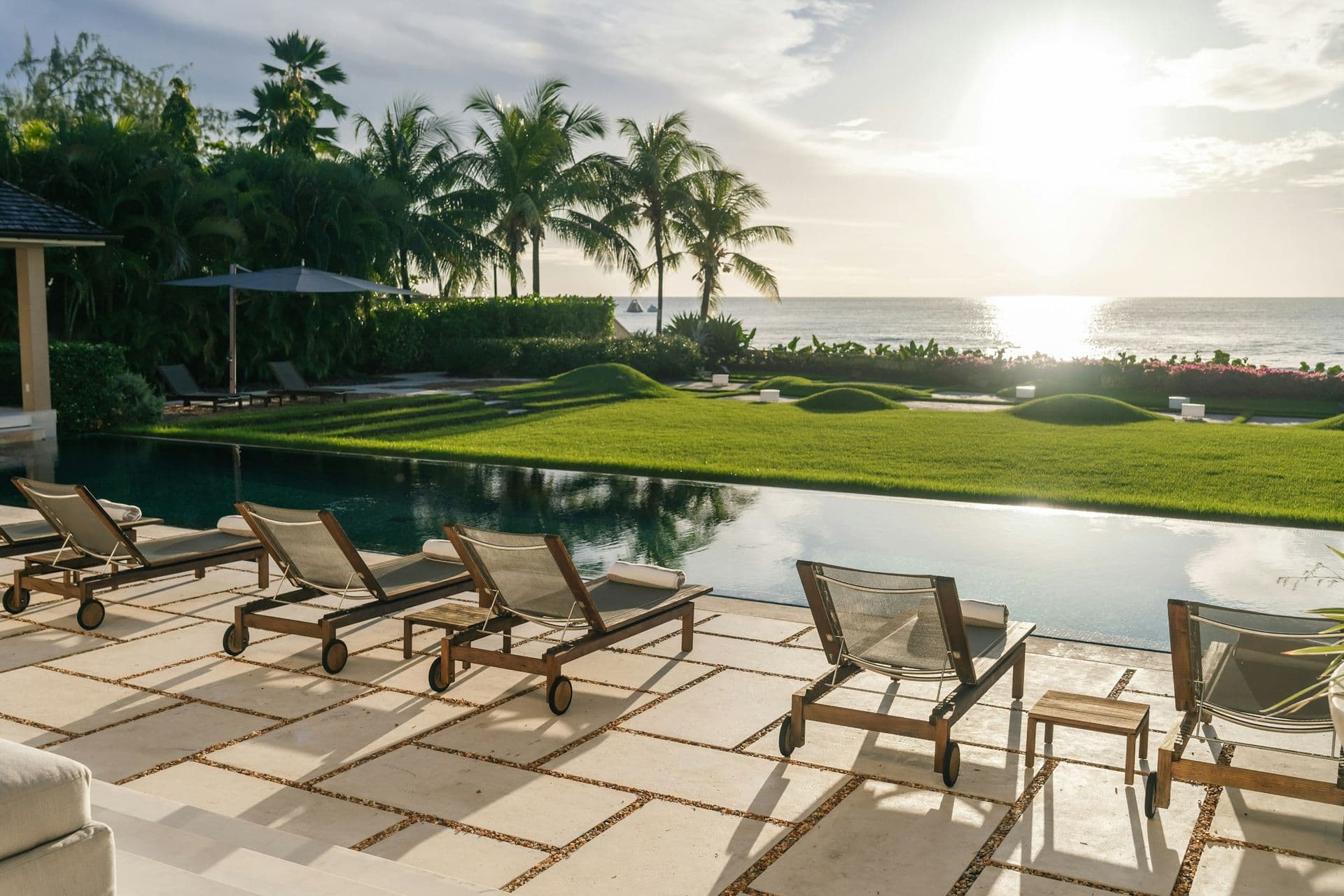 Pool and loungers at sunset over the sea at Moonlight Beauty, Barbados