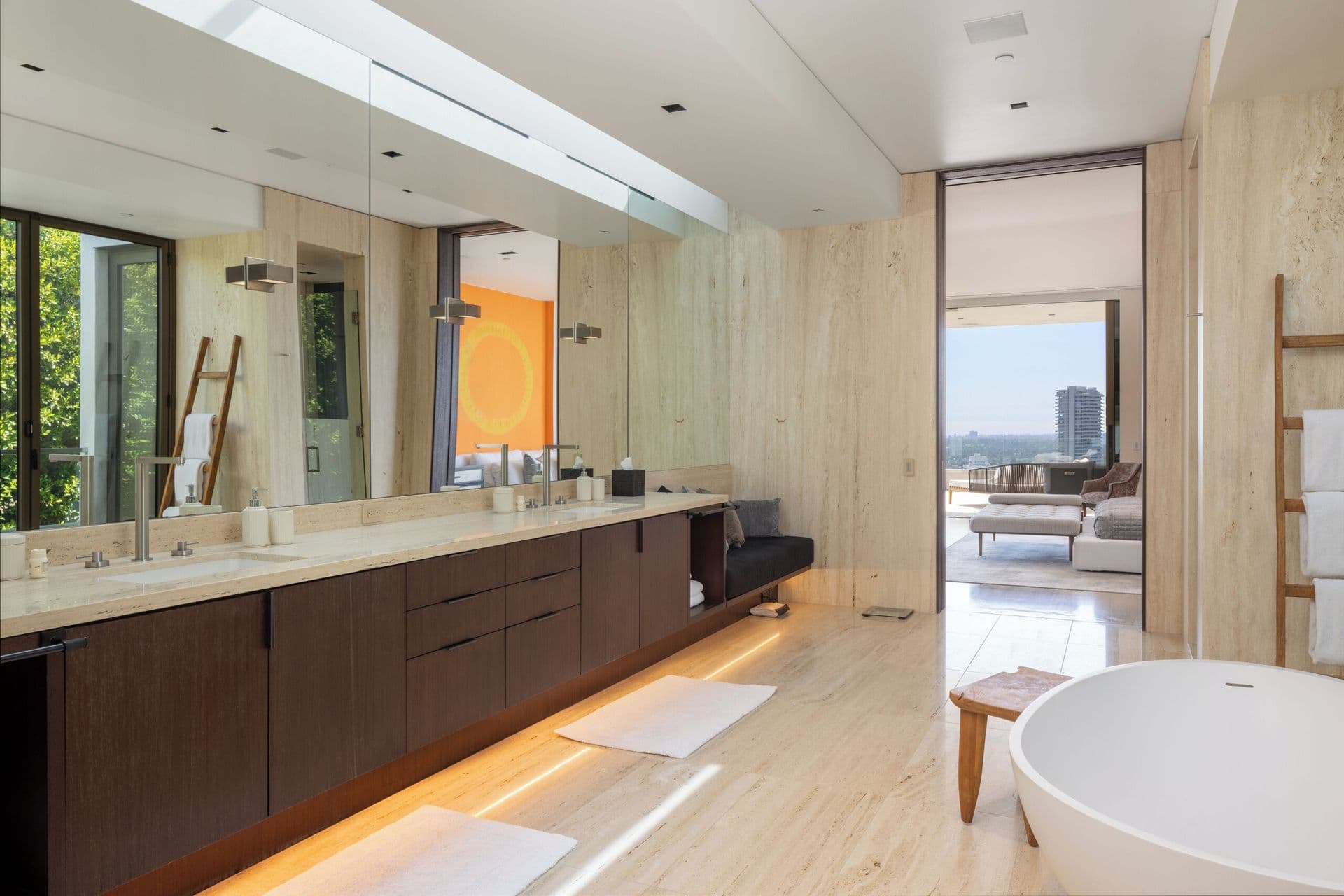 Bathroom with a long double vanity and full-length mirror wall