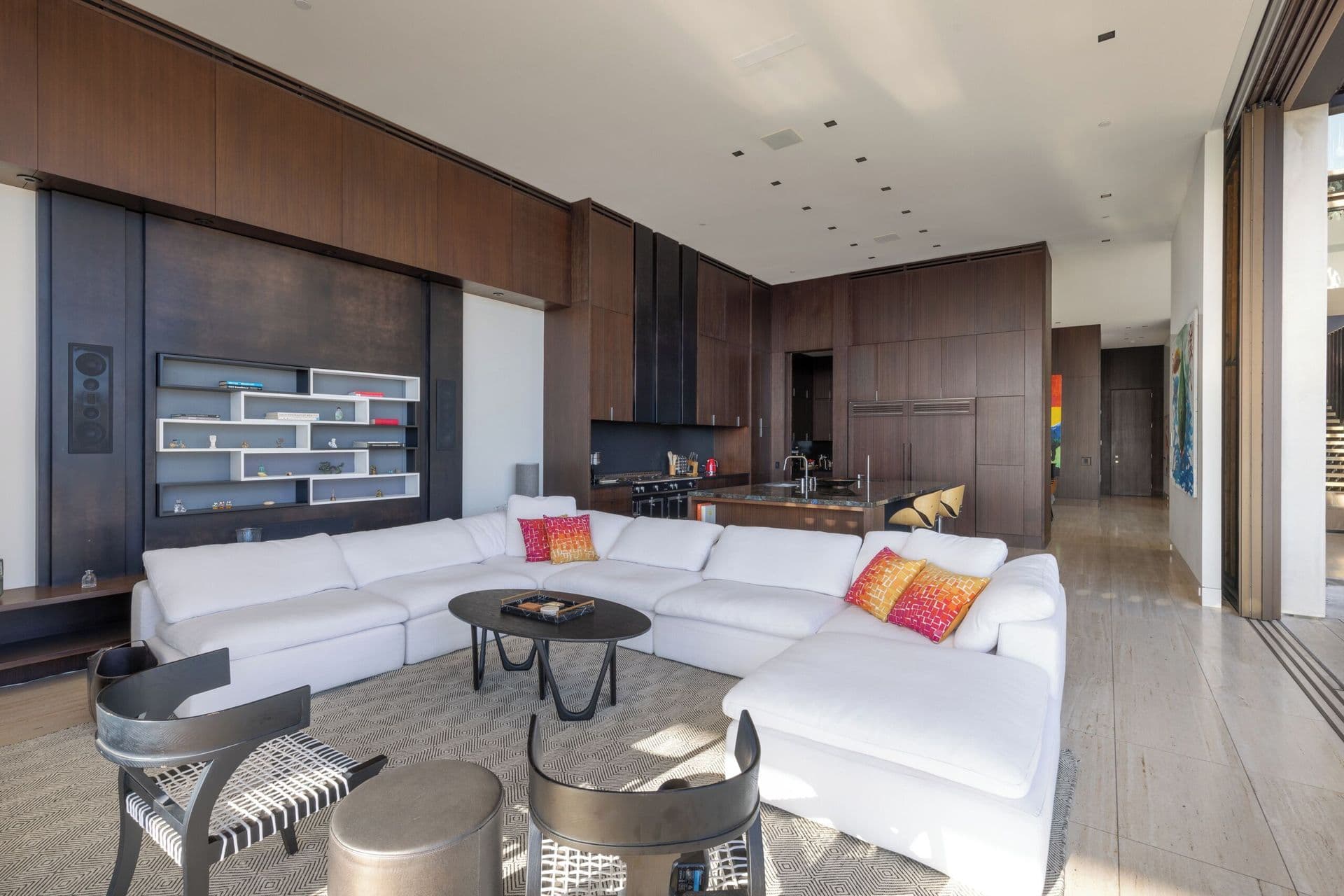 Family room with a large white sectional sofa and wall-mounted television