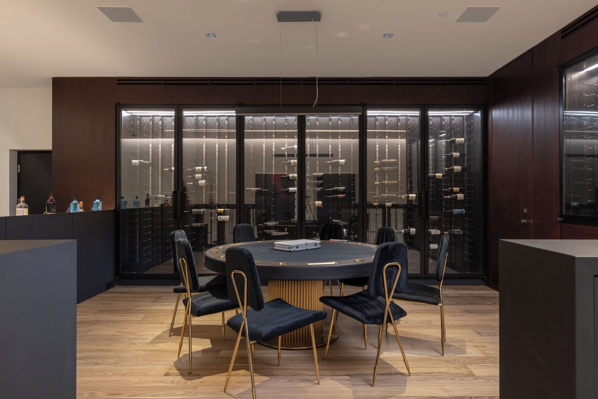 Open-plan kitchen and dining area with dark cabinetry and a round dining table
