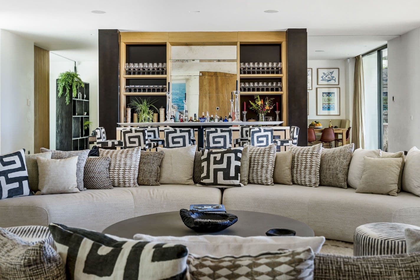 Lounge with a long sofa opening to a built-in bar at Aphrodite's Oasis, Ibiza