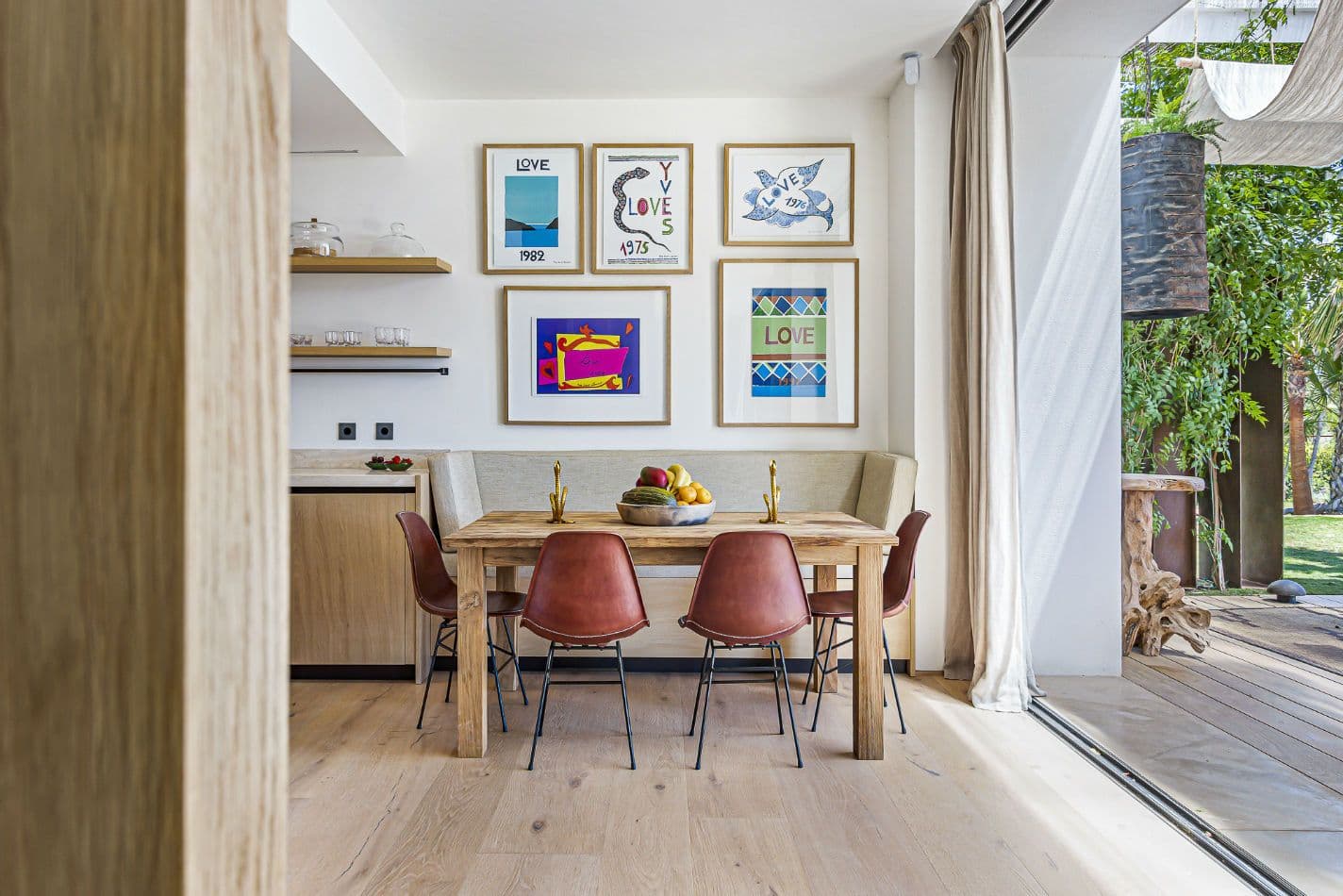 Breakfast nook with an oak table and tan leather chairs at Aphrodite's Oasis, Ibiza