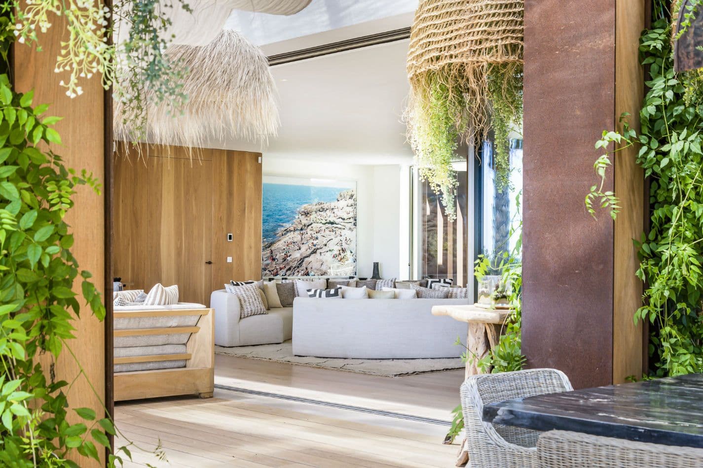 Master bedroom with woven pendants, greenery and sea views at Aphrodite's Oasis, Ibiza