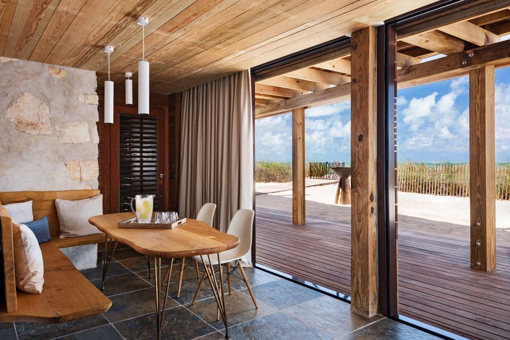 Breakfast nook with banquette seating opening to the beach at Silver Sands