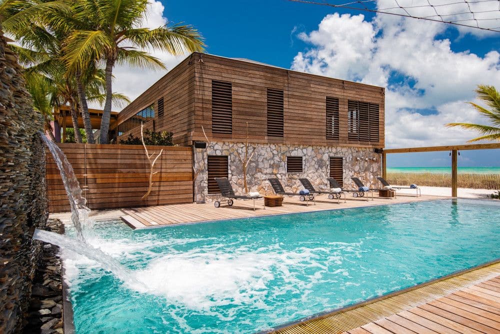 Silver Sands, a timber and stone beachfront villa with a pool and waterfall on Providenciales
