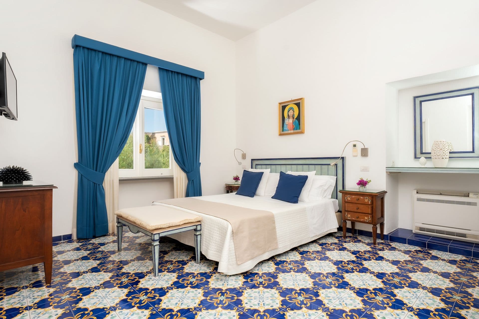 Twin bedroom with blue curtains and a glimpse of the sea at Graceful Sea