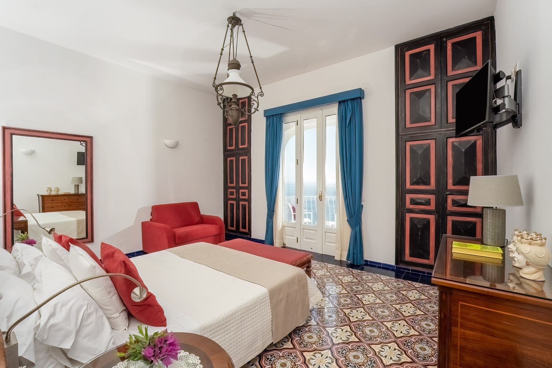 Guest bedroom with twin beds and ornate mirrored dresser at Graceful Sea