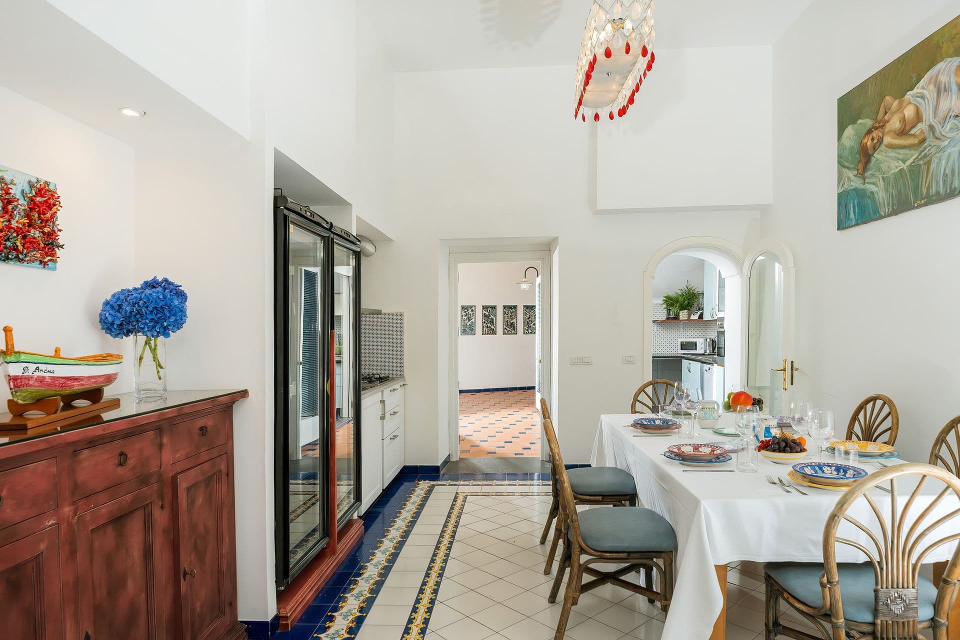 Indoor dining room with patterned tile floor and coastal artwork at Graceful Sea