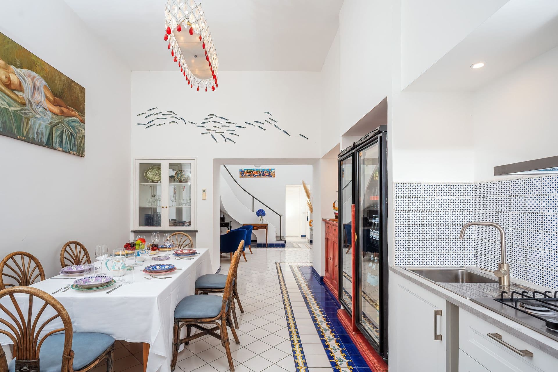 Kitchen with handpainted blue tile flooring and garden views at Graceful Sea