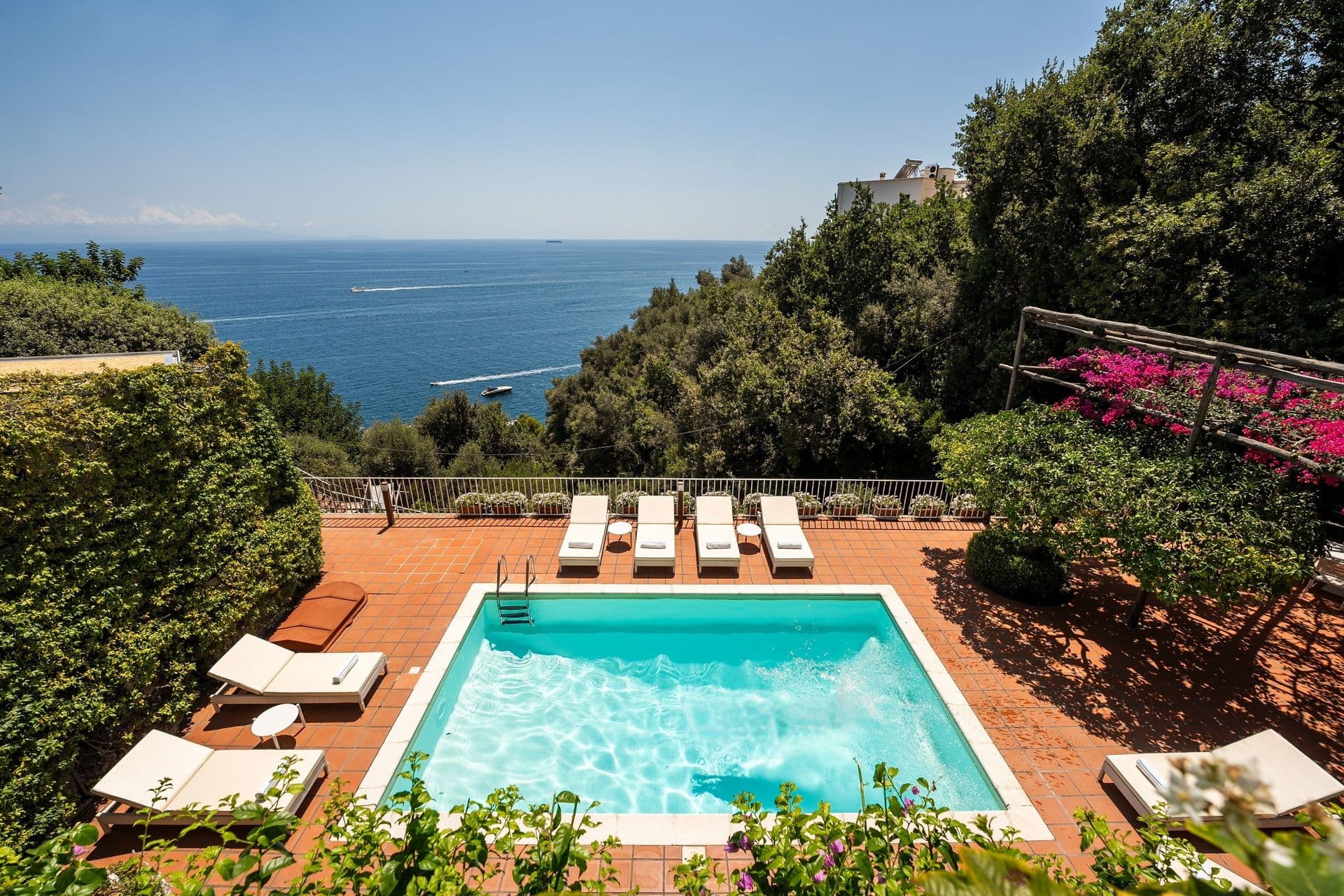 Rectangular swimming pool with sun loungers overlooking the Amalfi coastline at Graceful Sea, Salerno