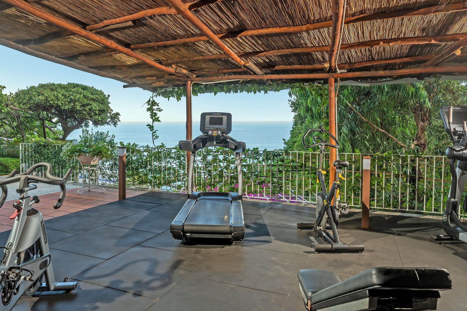 Private terrace gym with cardio equipment and uninterrupted sea view at Graceful Sea
